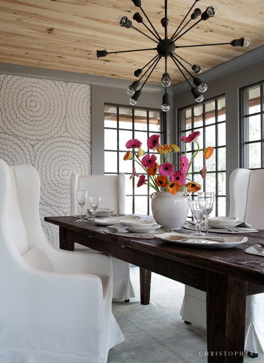 Transitional Estate Dining Room with Feather Bloom Schumacher Wallcovering Accent Wall and Pecky Cypress Ceiling