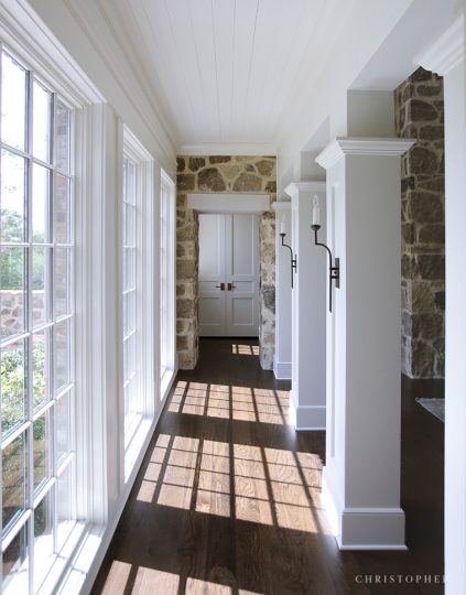 Christopher Architecture and Interiors Countryside Estate Light Filled Hallway Transition with Shadows from Windows